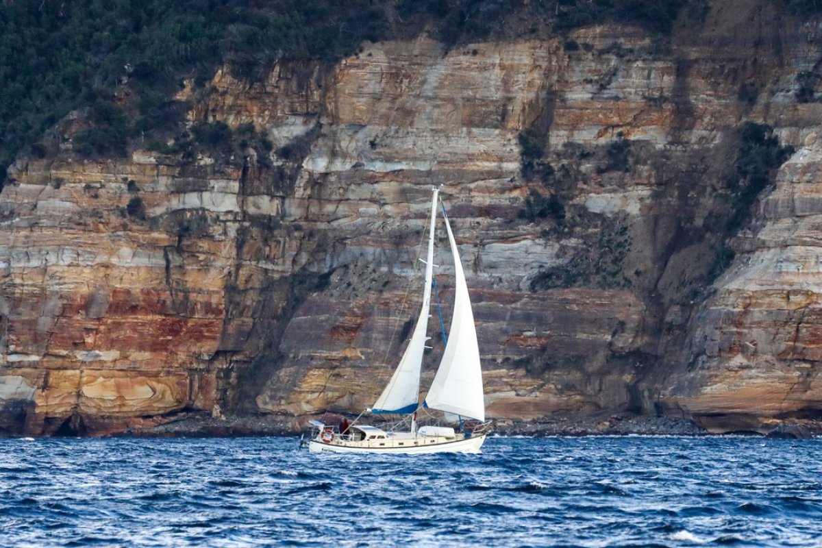 Swanson 38:tarima sails north past Cape Bernier bound for warmer waters. Photo:Nick Jaffe