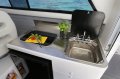 Thomascraft - Saloon opens onto a huge rear deck:Stainless steel galley with gas stove and sink