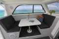 Thomascraft - Saloon opens onto a huge rear deck:Table lowers to create additional berth