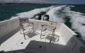 Thomascraft - Saloon opens onto a huge rear deck:Stainless steel galley with gas stove and sink