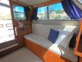 Randell 32 Flybridge Cruiser Shaft drive diesel - what a cracker!!:Port side lounge converts to single berth