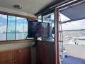 Riviera 34 Flybridge Cruiser " Dual Helm, Dual shaft Diesels ":Tv facing dinette