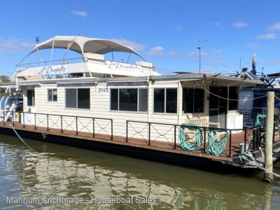 Historic two deck, stern paddle wheel houseboat