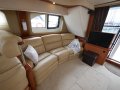 Silverton 43 Sport Bridge:Main Cabin with TV which drops into a cabinet electronically