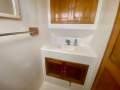 Perry 43 Sailing Catamaran Central elevated helm version:Port midships bathroom