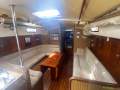 Savage Oceanic Savage Oceanic 13 with Sugar scoop 46':Passage to aft cabin. Sail storage on left and engine access on right with Victron charge.