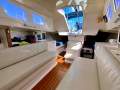Eureka 10.4 Sports -Affordable & well-equipped 2-hander Racer-Cruiser:Plush cream vinyl settees with under seat storage lockers