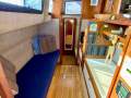Simpson Cloud 12 Re-powered, re-rigged, superbly presented cruiser:Port hull looking forward with pilot berth, nav station leading forward to cabin
