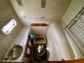Simpson Cloud 12 Re-powered, re-rigged, superbly presented cruiser:Port hull (fwd) laundry area
