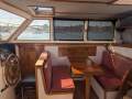 Ted Brewer Pilot House Cutter:Pilot House Inside Helm and Dinette